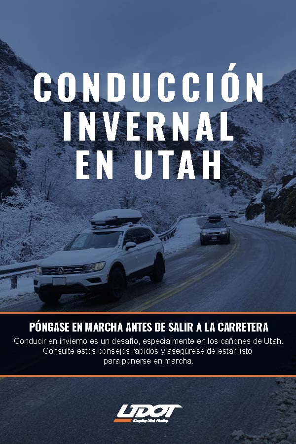 Snowy canyon road scene with two SUVs driving through wintry mountains